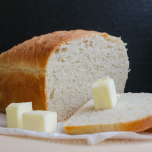 loaf of homemade white bread on a white ceramic plate