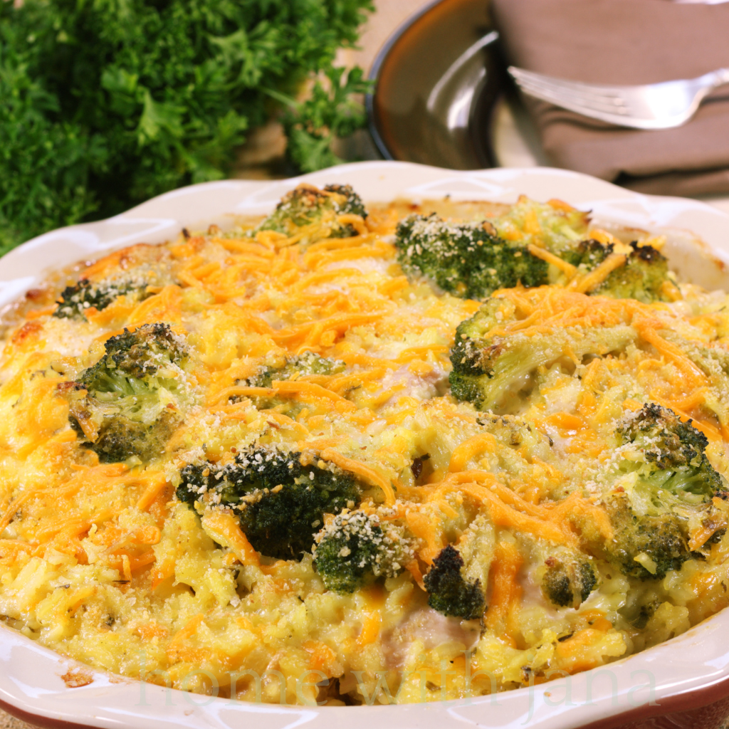 Creamy chicken broccoli and rice casserole on a white dinner plate.