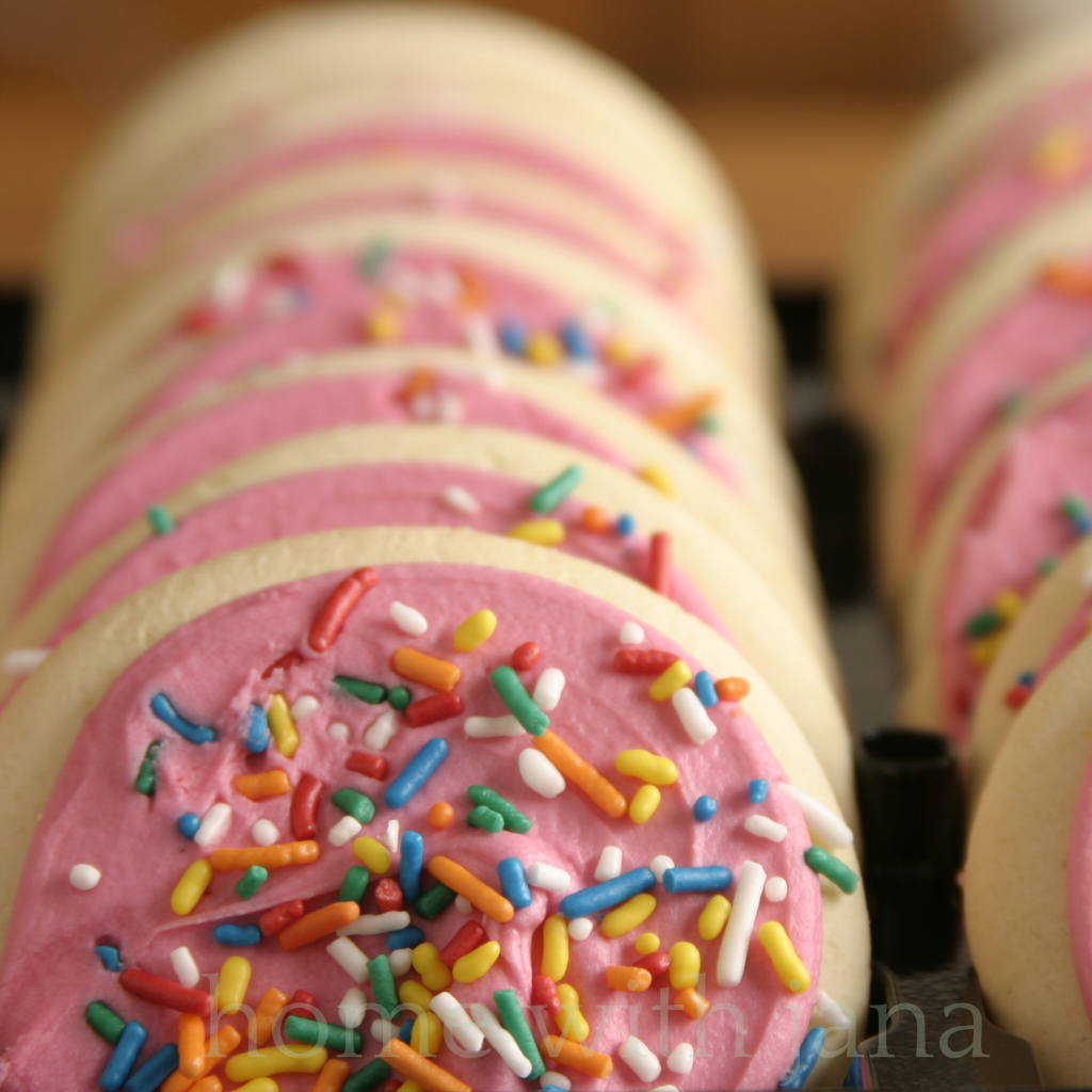 Decorated sugar cookies with pink frosting and sprinkles.