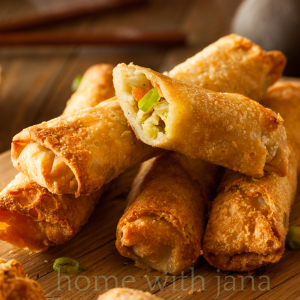 Crispy homemade egg rolls served on a wooden board