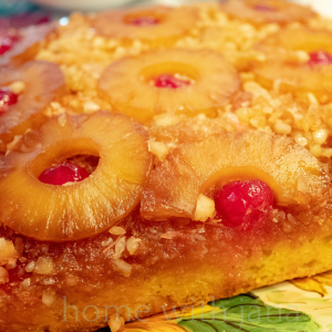 Close-up of a homemade pineapple upside down cake with caramelized pineapple rings and cherries by Home with Jana