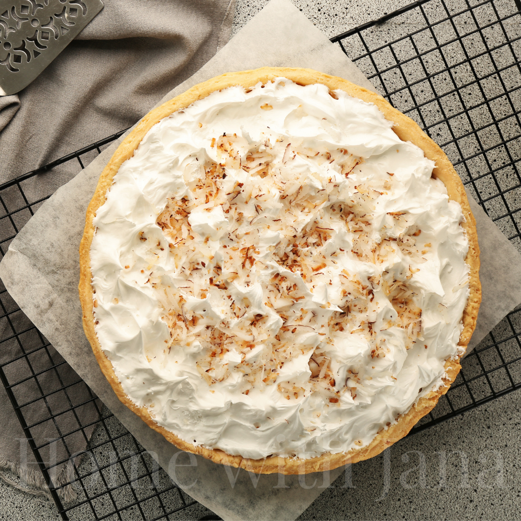 Coconut cream pie topped with whipped cream and toasted coconut