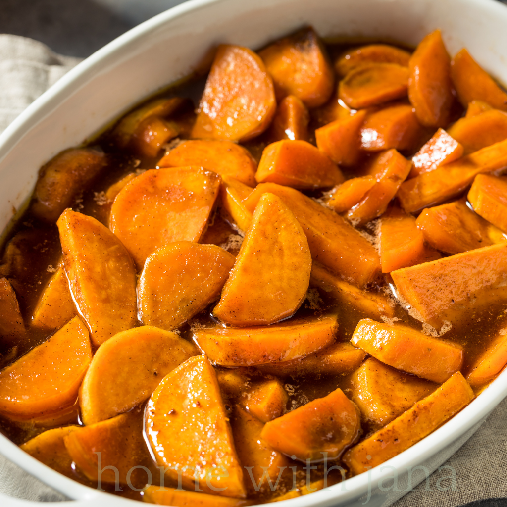 Baking dish of homemade candied yams with sweet brown sugar glaze