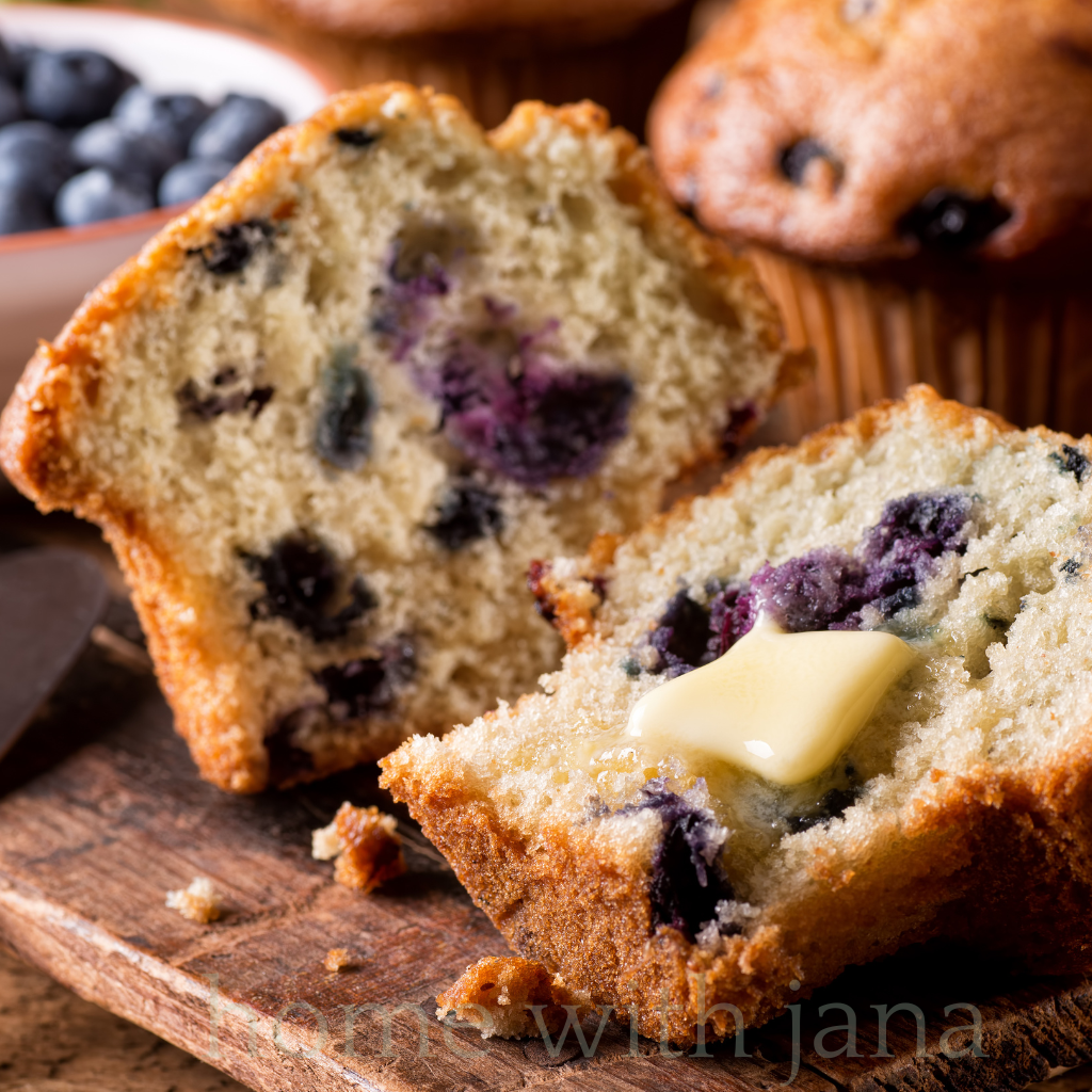Close-up of golden-brown blueberry muffins with sugar-dusted tops and bursting blueberries, inspired by the original 1980s Jordan Marsh recipe