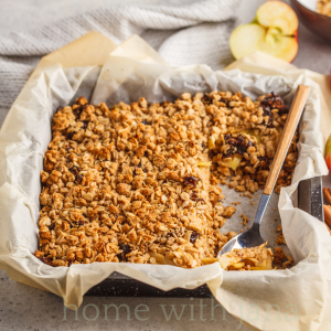 Baked Caramel Apple Crisp in a parchment lined baking sheet.