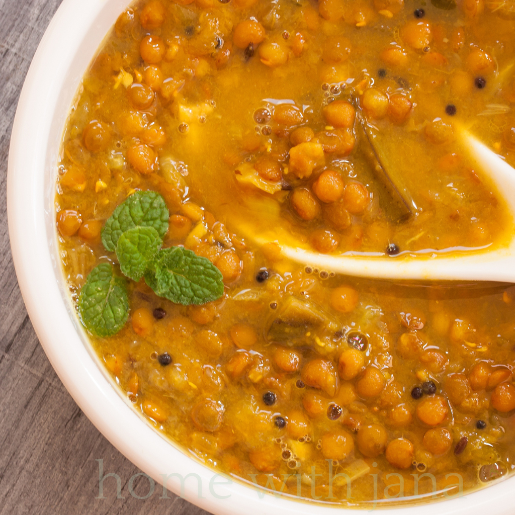 Bowl of homemade lentil soup with red lentils, spices, and fresh mint garnish