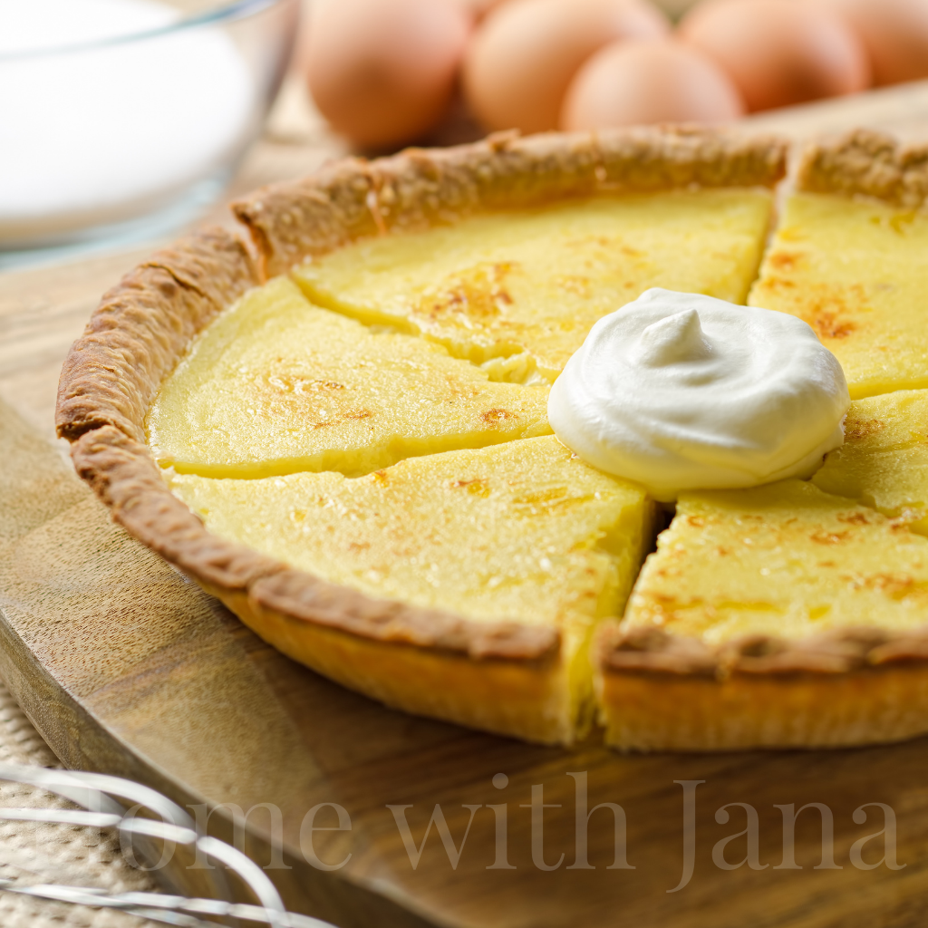 A homemade custard pie with a dollop of whipped cream.