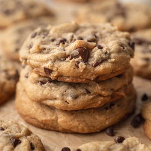Stack of thick chewy chocolate chip cookies with soft centers and melted chocolate chips